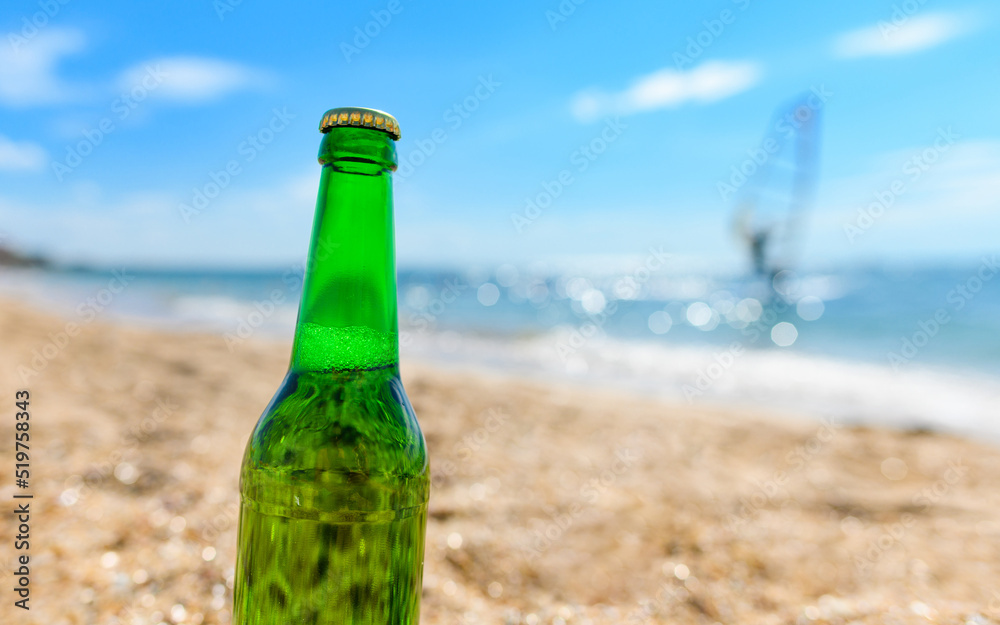 Bottle of beer close-up on the sea shore. Vacation concept. Bottle of beer close-up on the sea shore. Vacation concept.