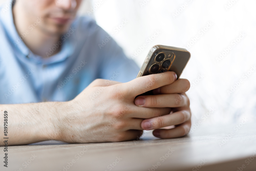 Man with a finger on the screen using a mobile phone in the office. Man with a finger on the screen using a mobile phone in the office.