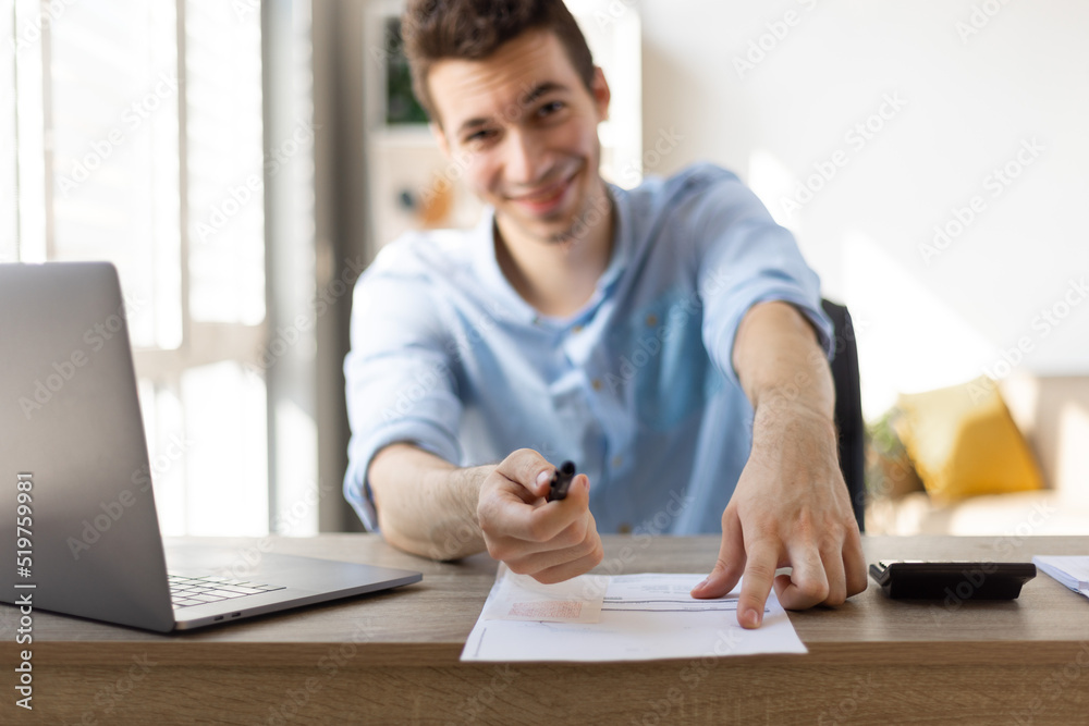 Front view of businessman pointing to a contract where to sign, vintage effect toned image.. Front view of businessman pointing to a contract where to sign, vintage effect toned image..