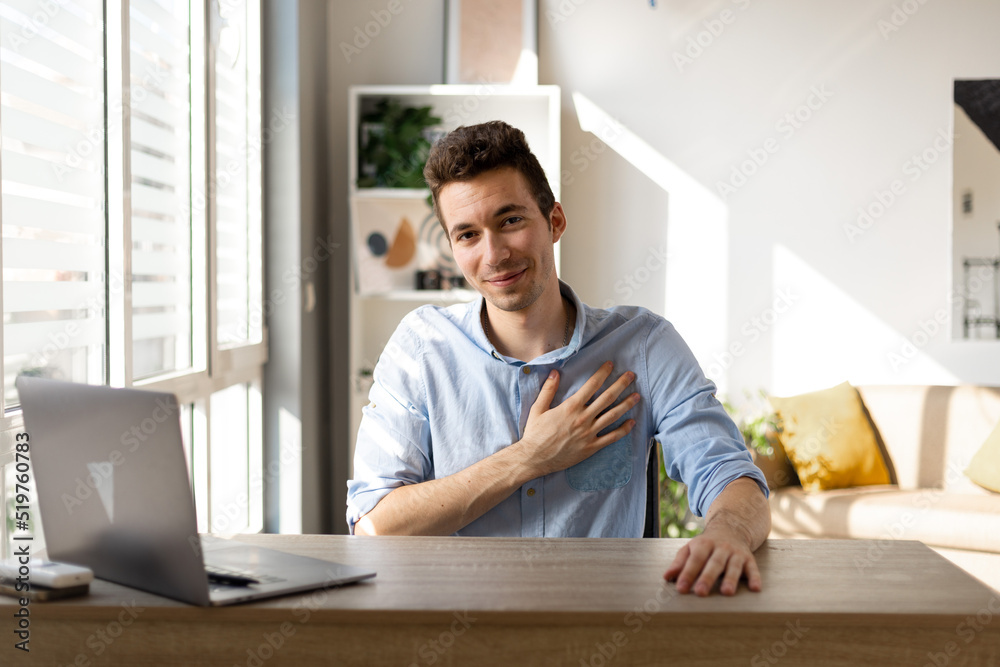 Handsome businessman in his office smiling with hands on chest, grateful gesture on face. Handsome businessman in his office smiling with hands on chest, grateful gesture on face.