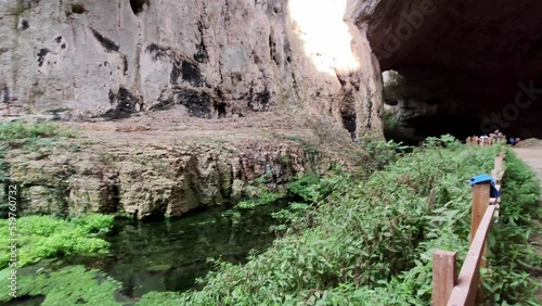 Devetashka cave, located near Letnitsa and Lovech, Bulgaria is a major tourist attraction.  The cave has been visited since Paleolithic times.  The clip provides a quick glance over the base and cave. photo