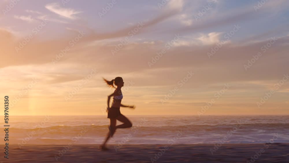 Fit and active jogger running by the ocean and beach shore with sunset sky background and copy space. Beautiful view of a sporty female athlete exercising or doing endurance workout outdoors Fit and active jogger running by the ocean and beach shore with sunset sky background and copy space. Beautiful view of a sporty female athlete exercising or doing endurance workout outdoors