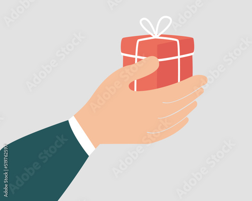 Gift box to celebrate birthday or anniversary. A hand of a woman or a man holding a surprise gift as a sign of love. Concept of Christmas celebration, philanthropy and charity. Vector illustration