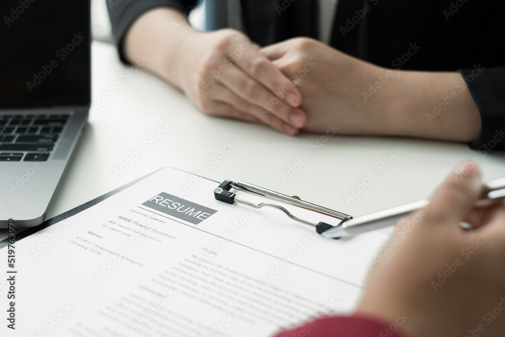 Business people hold a resume and talk to job applicants for job interviews about careers and Their personal history in the company. Recruitment concepts Business people hold a resume and talk to job applicants for job interviews about careers and Their personal history in the company. Recruitment concepts