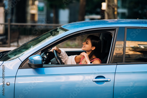 Beautiful Smiling woman driving car, girl sitting in automobile © teksomolika