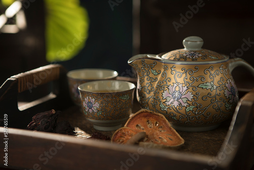 Close up view of nice china teapot and glasses on color back photo