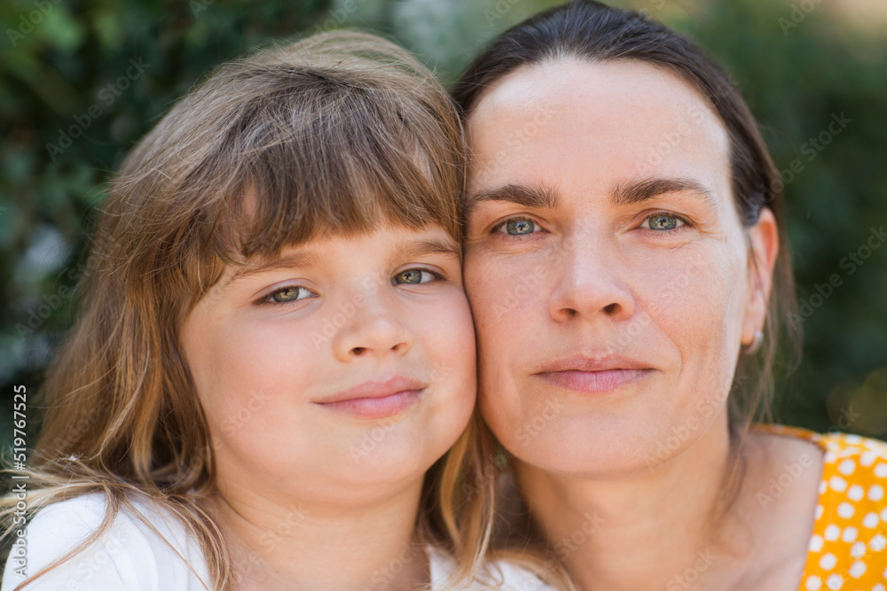 portrait of mother and little daughter in nature on a summer day. Happy family portrait of mother and little daughter in nature on a summer day. Happy family