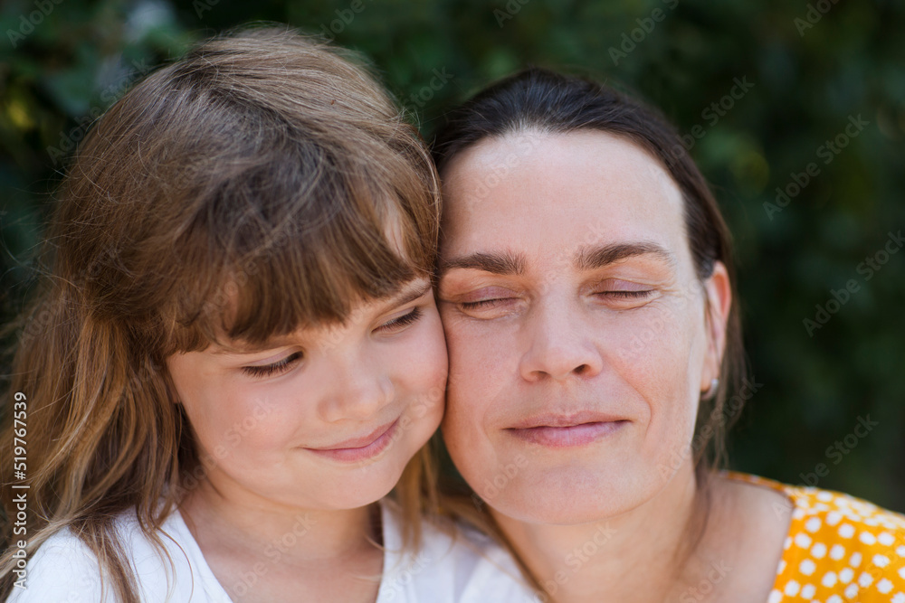 portrait of mother and little daughter in nature on a summer day. Happy family portrait of mother and little daughter in nature on a summer day. Happy family