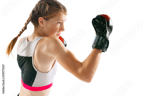 Female junior MMA fighter in sports uniform training isolated on white background. Concept of sport, competition, action, healthy lifestyle. photo