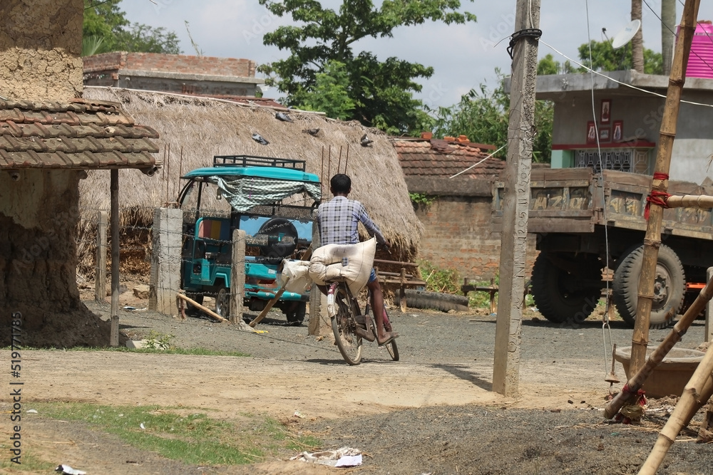 Indian or asian village scene. A battery powered tricycle rickshaw van ...