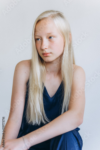 Young blondie caucasian girl on white background. Natural beauty, no make up, casual lifestyle girl. Young face