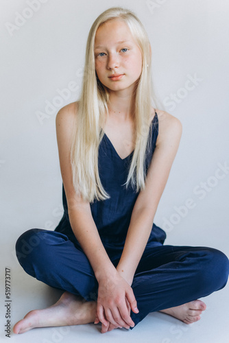 Young blondie caucasian girl on white background. Natural beauty, no make up, casual lifestyle girl. Young face