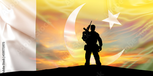 Silhouettes of a soldier on a background of Pakistan flag and the sunrise. Pakistan independence day concept background