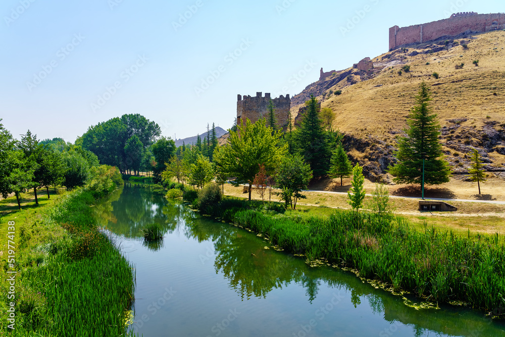 Ucero river passing quietly next to the wall of the medieval city of Burgo de Osma, Soria.