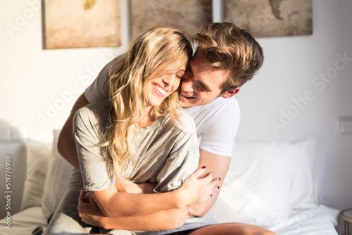 happy young couple relaxed at home on bed photo