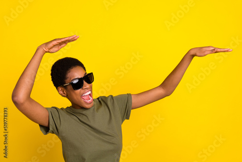 Portrait of overjoyed satisfied person have fun clubbing isolated on yellow color background