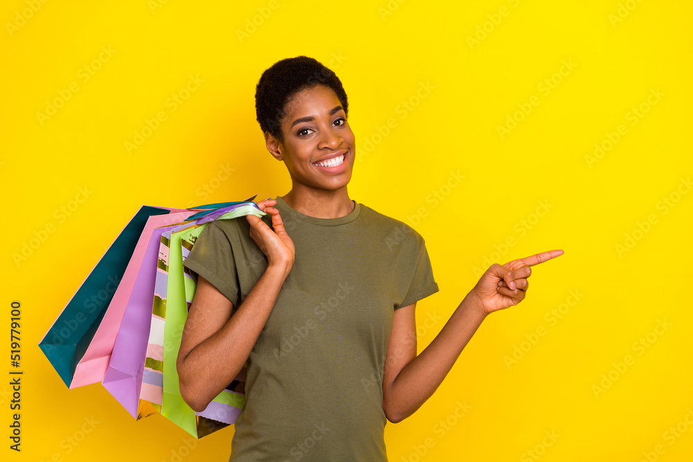 Portrait of cheerful nice person direct finger empty space proposition isolated on yellow color background Portrait of cheerful nice person direct finger empty space proposition isolated on yellow color background