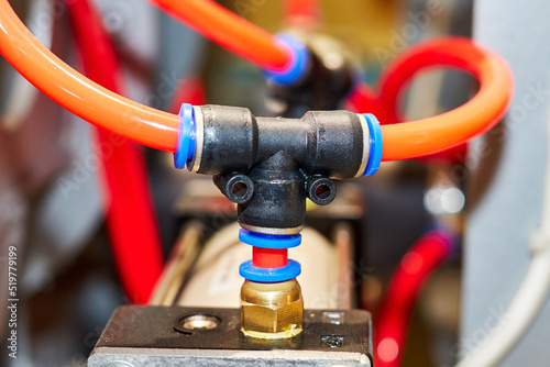 pneumatic system tubes connected to the tee and pneumatic cylinders