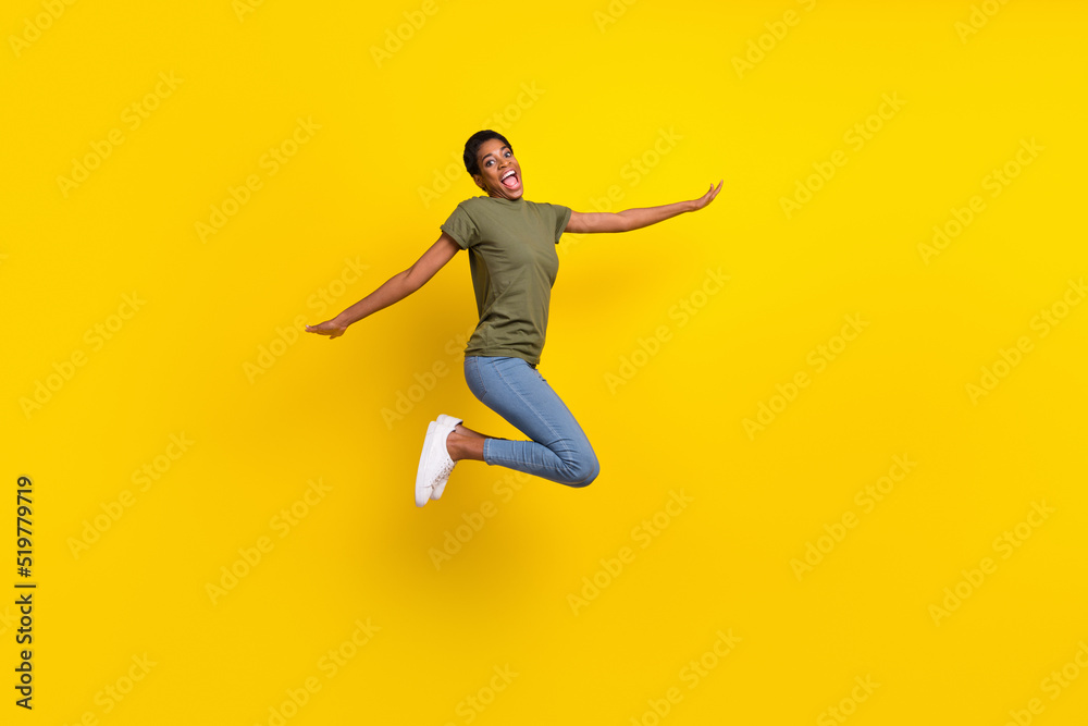 Full body photo of overjoyed person jump fly have good mood isolated on yellow color background