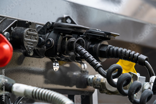 Pneumatic pumping hoses and connections of the body with the trailer to the truck. Closeup of pneumatic hoses for supplying compressed air to the truck. Semi-trailer, Truck MOT maintenance repair. © 360VP