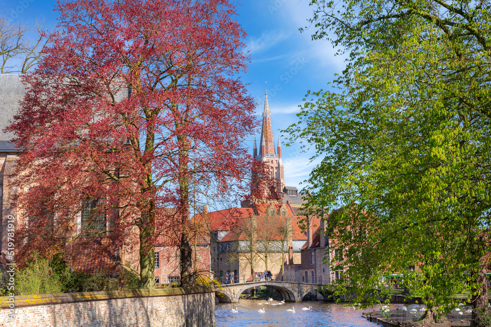 Canal and bridge view, church in Bruges, Belguim