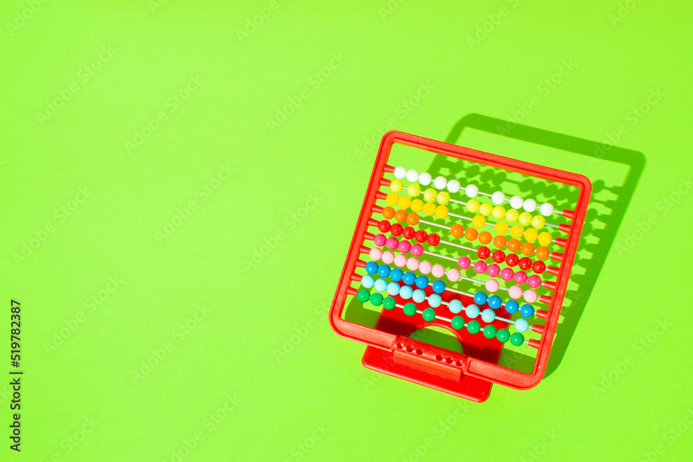 Minimal composition made of abacus on bright green backgrpund. Creative back to school concept. Minimal composition made of abacus on bright green backgrpund. Creative back to school concept.