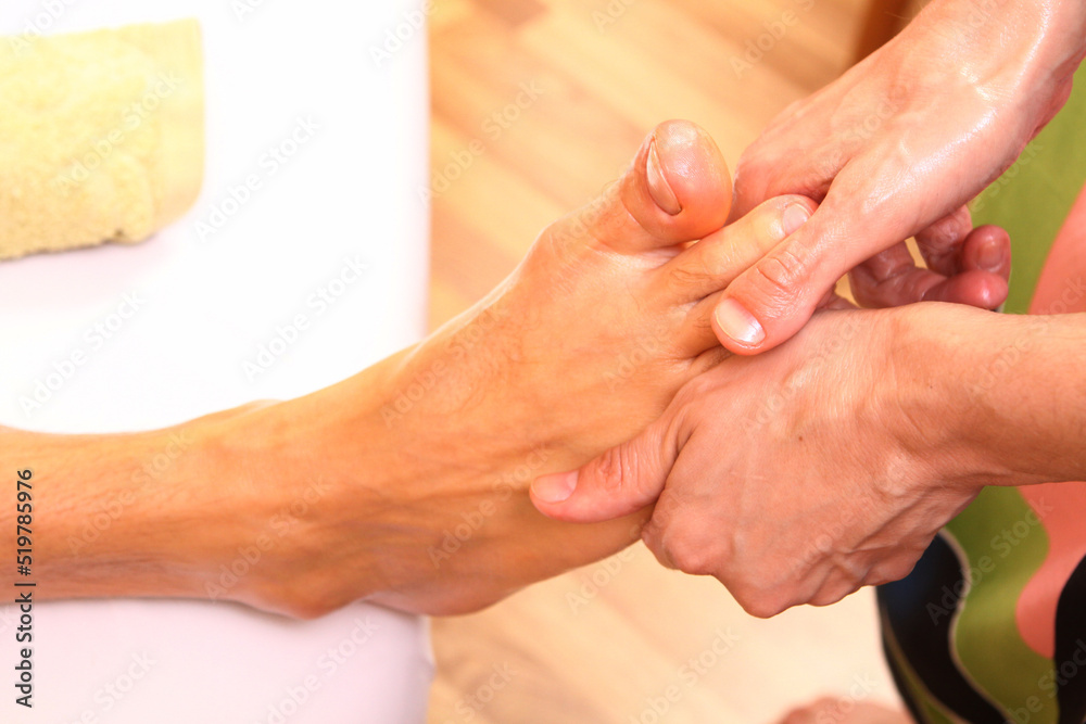 Obraz premium Two girls give a Hawaiian massage to a man. Thai massage performed by people. Banner for advertising Thai massage.