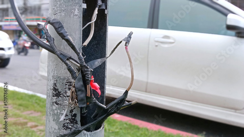 фотографія Defective power cables untidy on safety concept poles.