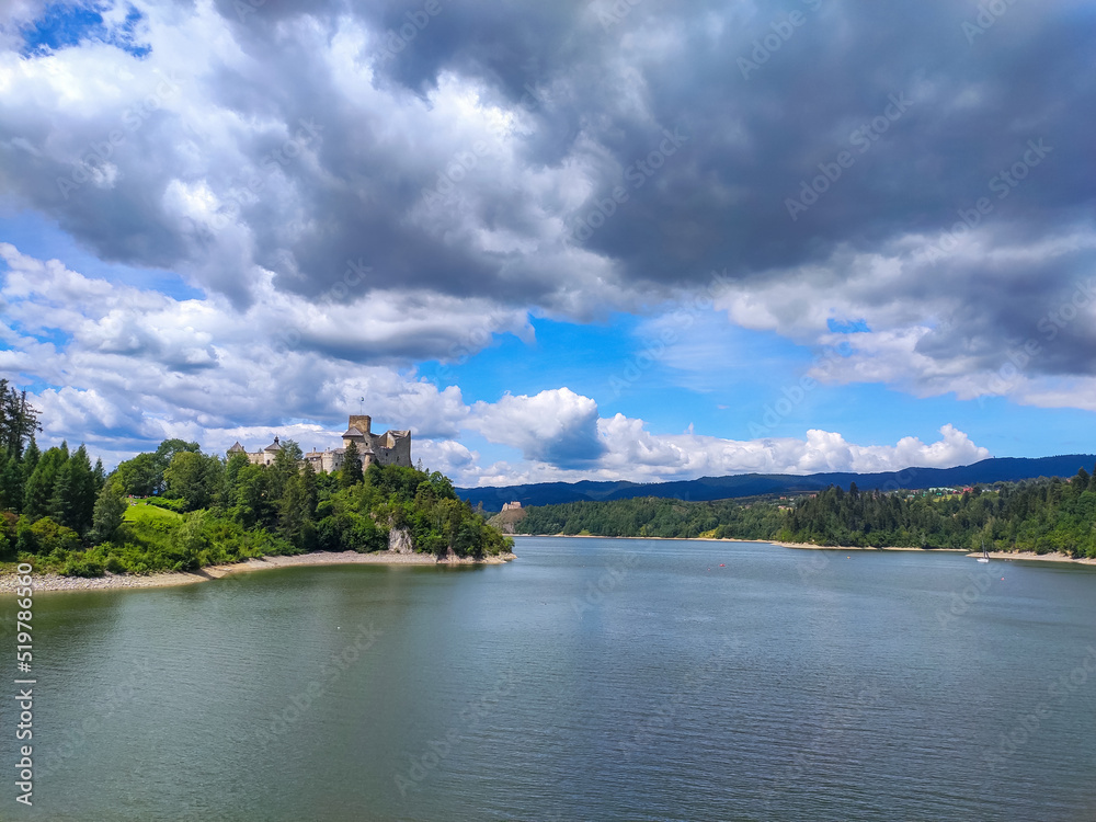 Niedzica Castle Also Known as Dunajec Castle by Lake Czorsztynin the Pieniny Mountains, Poland. And Tourist Ferrys in the Lake. Summer Day With Fast Moving Clouds.  Czorsztyn Castle at the Background