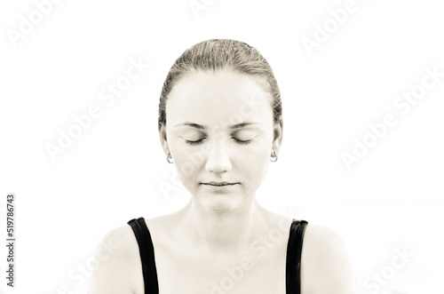 Young adult woman with beautiful face, clean healthy skin - isolated on white. Skin care concept. Closed eyes. Sepia