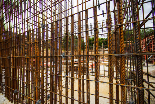 Construction steel rods or bars work reinforcement in conncrete structure of building.Background texture of steel rods used in construction to reinforce concrete
