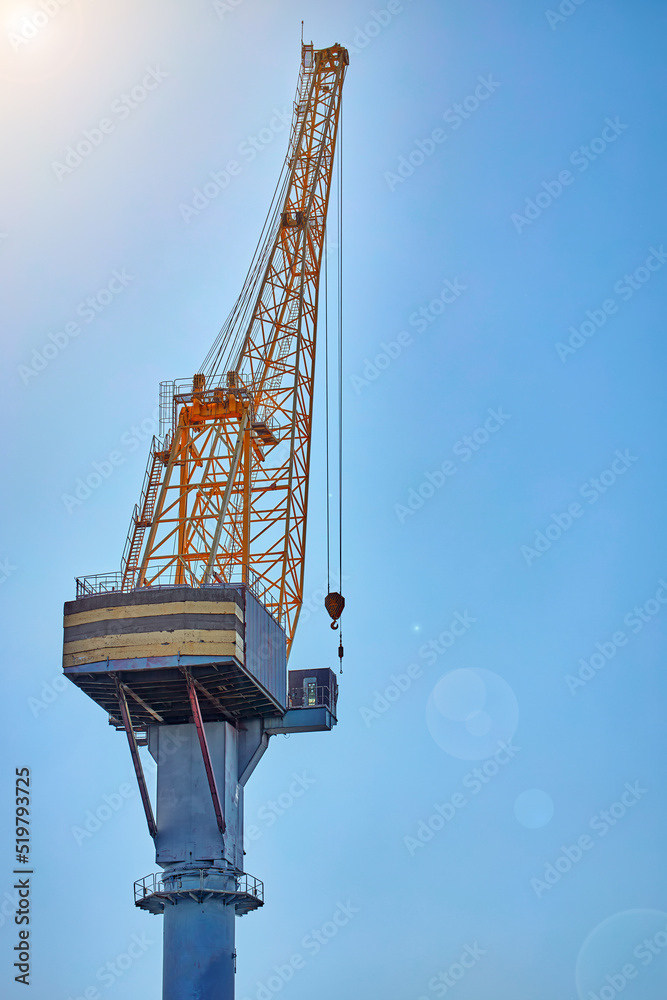 Naklejka premium Port tower crane against a blue sky.