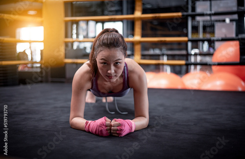 Young fitness woman doing push up exercises waring hand bandage to safe when exercise at gym  It s part of  fitness training workout bodybuilding healthy concept lifestyle.