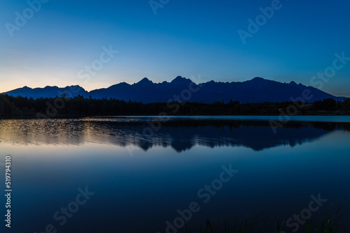 Sunset over a mountain lake and Tatras mountain in the background © ZT