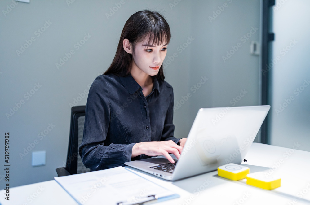 Working business women in conference rooms with black shirts and skirts Working business women in conference rooms with black shirts and skirts