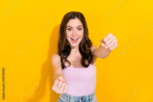Photo of cheerful satisfied person arms steering imagine wheel isolated on yellow color background