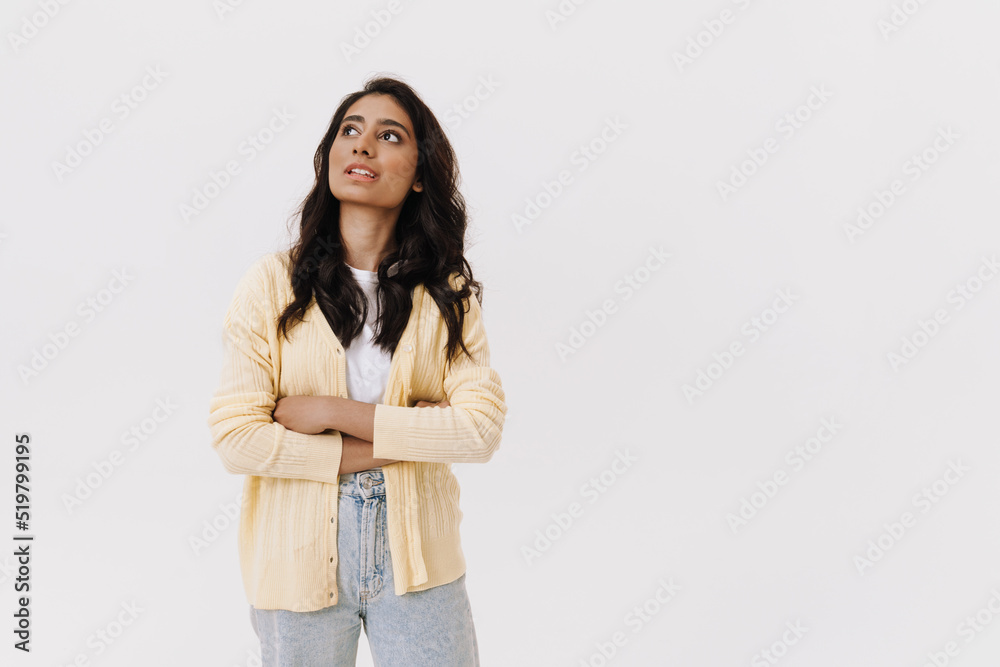 Young brunette indian woman looking upward while posing at camera Young brunette indian woman looking upward while posing at camera