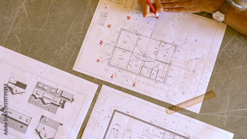 TOP DOWN: Young female using feng shui chart for energy flow analysis evaluation