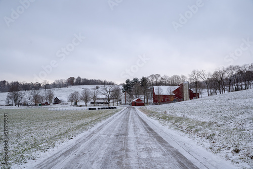 Snowy country road leading to an Amish farm in the countryside of Holmes county  Ohio