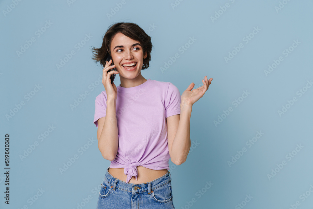 White young woman gesturing while talking on cellphone White young woman gesturing while talking on cellphone