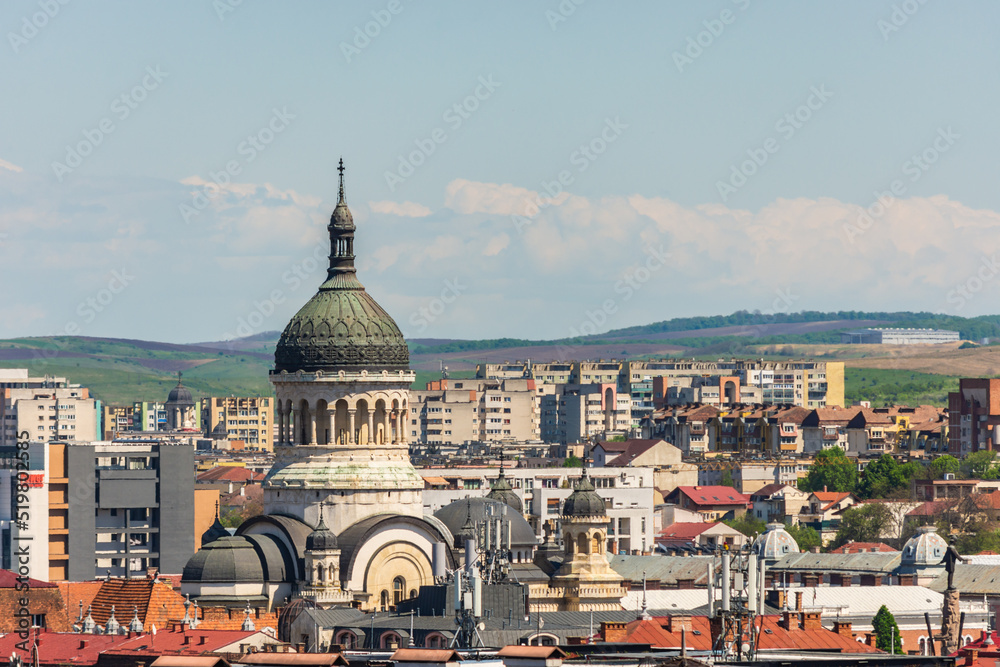 Orthodox cathedral or church from Cluj Napoca saw from an aerial cityscape with many vintage buildings among communist constructions