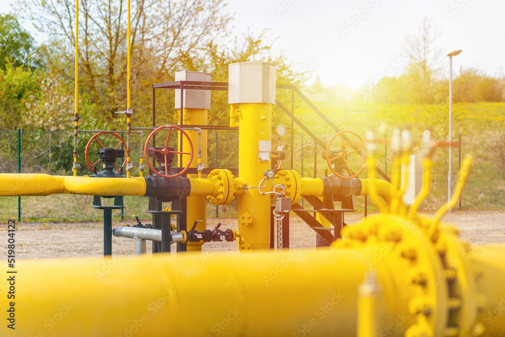 Valves at gas plant,pressure safety valve,blue sky,and sunlight,selective focus.Background for business.Summer time. Valves at gas plant,pressure safety valve,blue sky,and sunlight,selective focus.Background for business.Summer time.