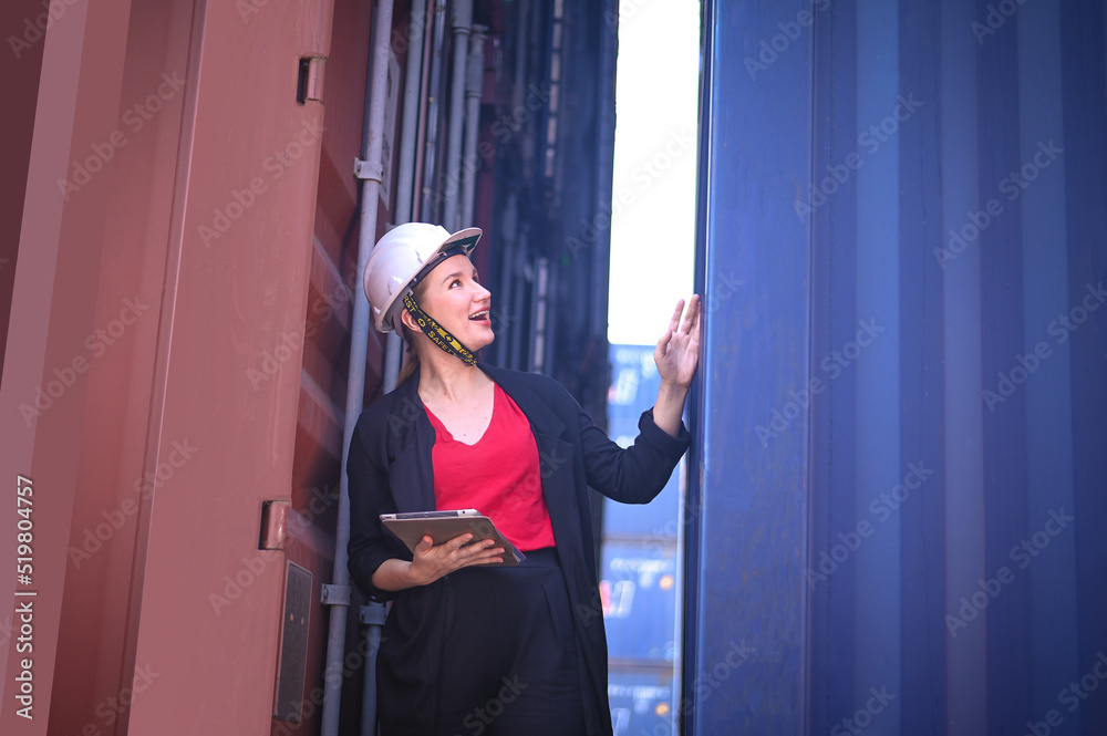 Female Engineer worker woman working checking at Container cargo harbor to loading containers. Female Engineer worker woman working checking at Container cargo harbor to loading containers.