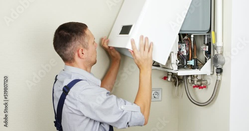 A plumber is attempting to fix a residential heating problem.