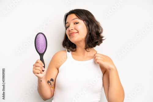 hispanic pretty girl feeling sad and whiney with an unhappy look and crying. hair comb concept photo