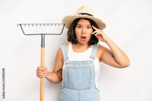 hispanic pretty girl feeling sad and whiney with an unhappy look and crying. farmer and rake concept photo