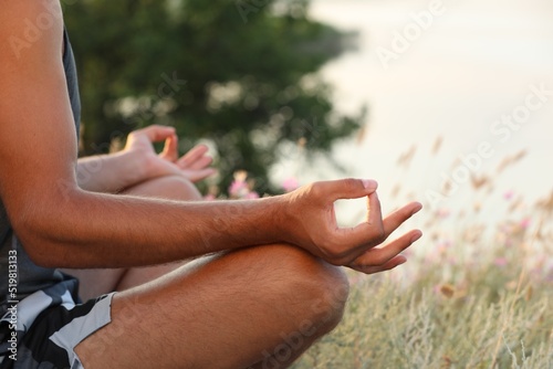 Man meditating outdoors on summer day, closeup