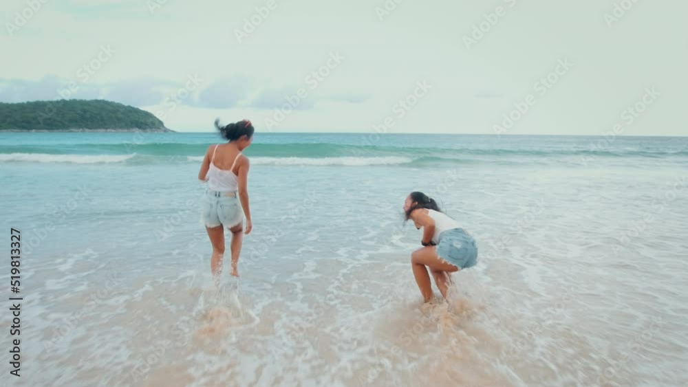 Two attractive women friends enjoying and relaxing on the beach, Summer, vacation, holidays, Lifestyles concept Two attractive women friends enjoying and relaxing on the beach, Summer, vacation, holidays, Lifestyles concept