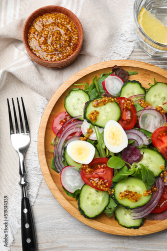 Tasty salad with vegetables and quail eggs on wooden table, flat lay
