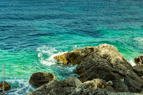Wallpaper Mural Close-up of a seagull sitting on a rock, rocks sticking out from the sea, sunny day, June, beautiful colors of water from bright green to blue Torontodigital.ca